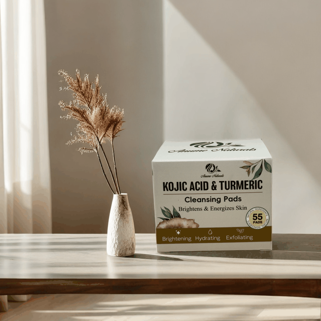 Anume Naturals Kojic Acid and Turmeric Cleansing Pads box on a table with dried floral decor, brightening and exfoliating skincare product.